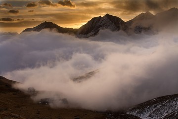 Great view of the foggy valley in Gran Paradiso National Park,  Alps, Italy,  dramatic scene, beautiful world. colourful autumn morning,scenic view with cloudy sky, majestic dawn in mountain landscape