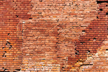 Red old worn brick wall texture background. Horizontal wide brick wall background. Vintage house facade.