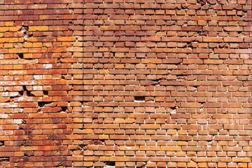 Red old worn brick wall texture background. Horizontal wide brick wall background. Vintage house facade.