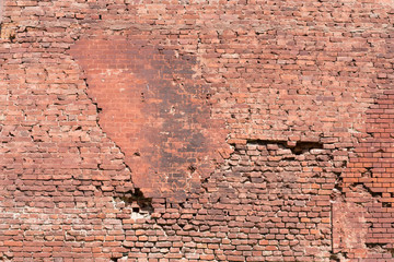 old dilapidated red brick wall