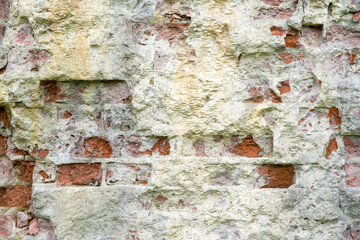 Old brick wall with damaged  layer, closeup background photo texture