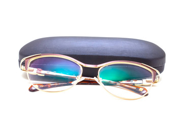 Sunglasses with spraying next to a black case