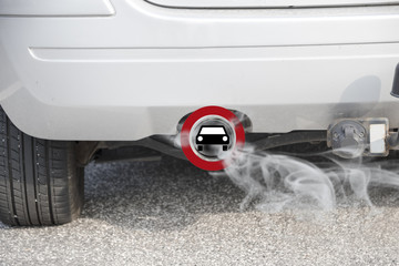 Exhaust from a car with the traffic sign for driving ban, in german Fahrverbot for diesel motor...