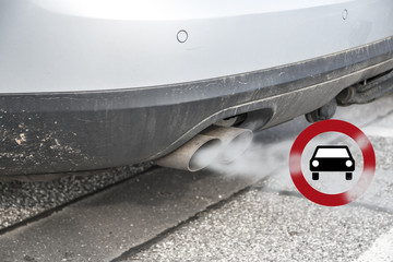 Double exhaust from a car with smoke and the traffic sign for driving ban, in german Fahrverbot for...