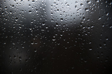 Raindrop on glass window, black and wight.
