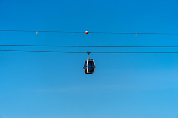 Summer natural landscape. A sunny day and hiking trails and cable car trails against the blue sky.