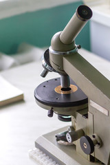 Old microscope. Real medical equipment for blood analysis.