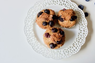 Tasty blueberry sweet muffins on the white plate.