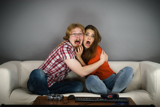 Funny couple watching horror movie