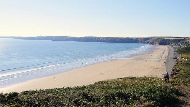 Walkers on the coast path over looking Newgale and St Brides Bay