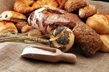 Different kinds of bread and bread rolls on burlap sack. Kitchen or bakery poster design