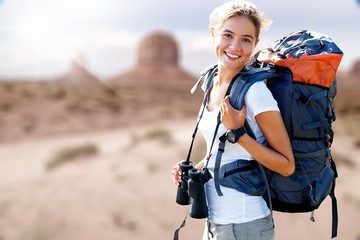 Woman with backpack trekking through the wilderness