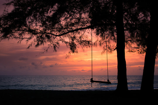 The silhouette of a swing background image. At Mai Khao Beach, Phuket, Thailand