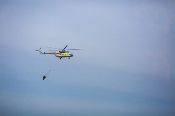 Fire in forest. Helicopter dpirs and drops water in epicenter of incident