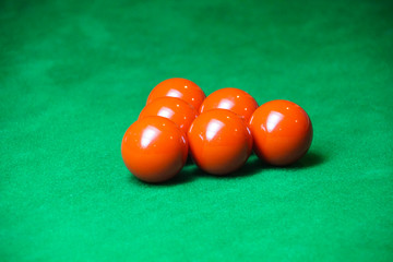 red snooker ball on snooker table