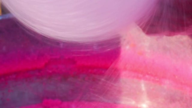 process of making pink sweet cotton wool on a special machine.Closeup
