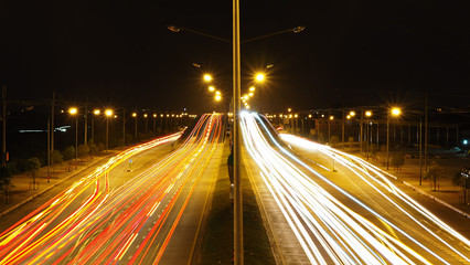 Fototapeta na wymiar Traffic light in the outer city,light trace,speed light background.