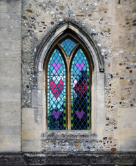 Fototapeta na wymiar Love for all - heart formed windows in gothic church in England.