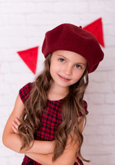 Portrait of little girl wearing a beret hat.
