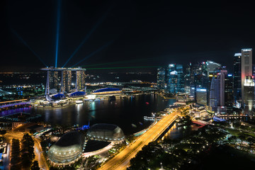 Fototapeta premium Colorful Singapore skyscraper building and laser show in night at Singapore.