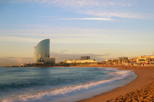 Fototapeta Barceloneta Beach in Barcelona with colorful sky at sunrise. Seafront, beach,coast in Spain. Suburb of Barcelona, Catalonia