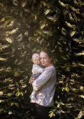 Portrait of mother and small daughter in beautiful landscape