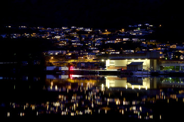 Fototapeta na wymiar Night city Odda in the reflection of water. Norway