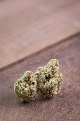 Cannabis buds on a wood board background
