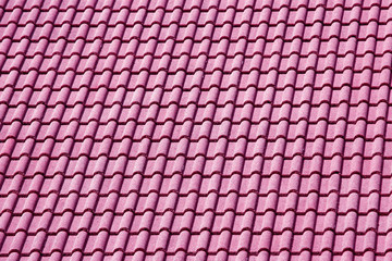 Decorative pink tiles on the roof of the house