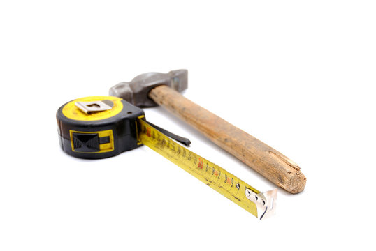 Tools collection - old tape measure and hammer