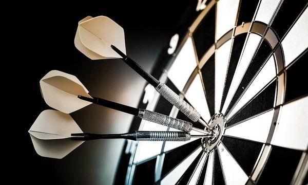 Dartboard with arrows on ackground