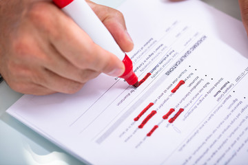 Businessperson Holding Marker On Document