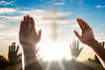 Human Hand Raising Hands With Cross In The Center