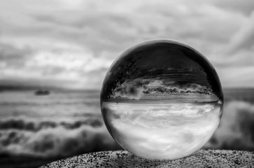 Black and White Stormy Surf and Sky Through Glass Ball
