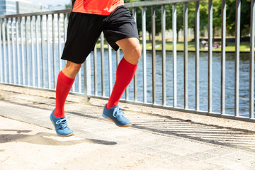 Man Running On Sidewalk At Morning
