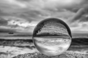 Black and White Stormy Sky and Sea with Glass Ball