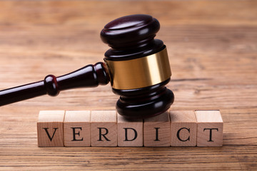 Gavel Over Wooden Blocks With Text Verdict