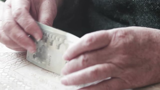 Senior woman hands counting 5 euro banknotes