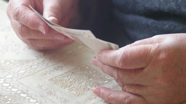 Senior retire woman counting little euro money