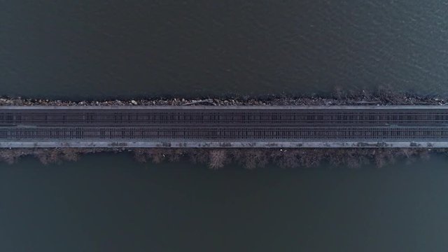 Top Down Aerial Zoom Out of Train Tracks Over Hudson River