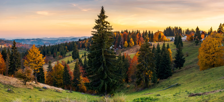 panorama of village outskirts in autumn. lovely landscape in mountains at sunset with gorgeous sky