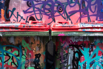 Two painted contamines on a colorful graffiti wall