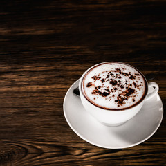 Hot chocolate cup on wood table.