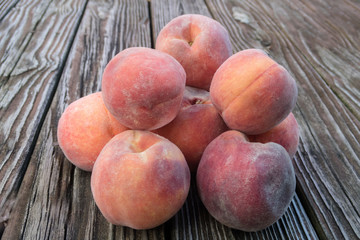 Fresh peaches on rustic wooden table