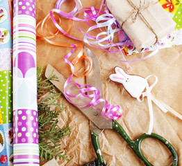 lot of stuff for handmade gifts, scissors, ribbon, paper with co