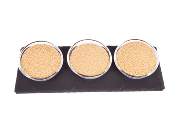 Raw organic amaranth grain on white background