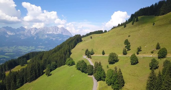 aerial drone footage of green alpine meadows and alpine mountains taken in the tyrol region of austria near kitzbuhel