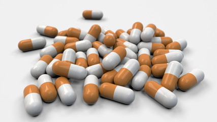 Pile of white and orange medicine capsules