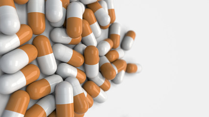 Pile of white and orange medicine capsules