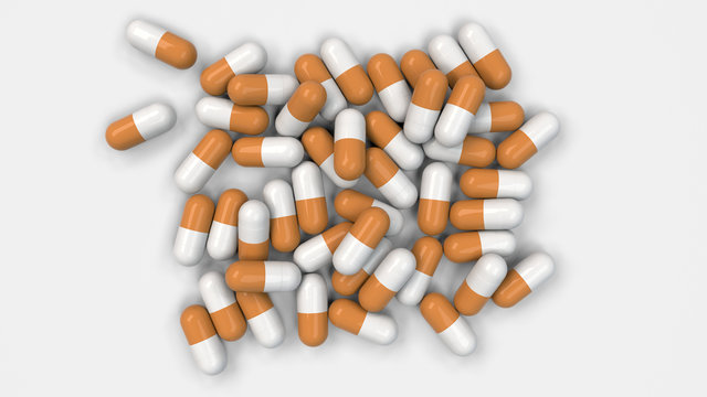 Pile of white and orange medicine capsules